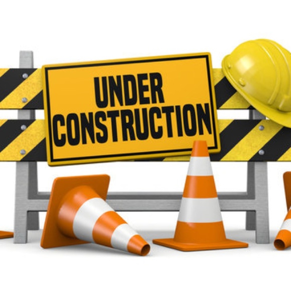 Under Construction Sign with Cones and Hard Hat